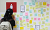 A woman writes a letter of condolence to a subway worker outside a public restroom at Sindang Station in Jung District, central Seoul, on Sep. 16, 2022, two days after the worker was stabbed to death by Jeon Joo-hwan, her former colleague. [YONHAP]