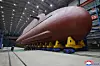 North Korean leader Kim Jong-un inspects on-site the construction of an 8,700-ton nuclear-powered strategic guided missile submarine, according to a report by the Korean Central News Agency on Dec. 25. [KOREAN CENTRAL NEWS AGENCY/YONHAP]