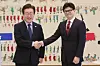 Democratic Party (DP) leader Lee Jae-myung, left, and People Power Party (PPP) leader Han Dong-hoon shake hands ahead of their official talks held at the National Assembly in Yeouido, western Seoul, on Sunday. [NEWS1]