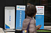 A passerby walks by signs about banks' loan programs in Seoul on Dec. 1. [YONHAP]