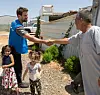 Actor Theo James, left, shakes hands with a Syrian man at the Azraq Refugee Camp in Jordan on July 25, 2023. James' grandfather fled Nazi-occupied Greece and found refuge in Damascus, Syria, during World War II. [UNITED NATIONS HIGH COMMISSIONER FOR REFUGEES]
