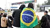 Fans await BTS member J-Hope in front of his base camp in Wonju, Gangwon, on Oct. 17. One fan is seen wearing the Brazilian flag around her shoulders. [YONHAP]