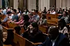 Faithful kneel during the first Sunday Mass following the election of Pope Leo XIV as the Catholic Church's new leader and first U.S.-born pontiff, at the Basilica of the National Shrine of the Immaculate Conception in Washington on May 11. [REUTERS]