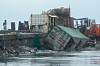 A man walks beside a container van that was toppled due to strong winds and waves caused by Typhoon Fung-wong on Monday, Nov. 10, 2025, along a coastal town in Navotas, Philippines. [AP/YONHAP]