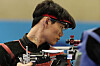 Korea's Choe Dae-han, with the Olympic rings on his neck, prepares to compete in the 10-meter air rifle men's final at the 2024 Paris Olympics in Chateauroux, France on Monday. [AP/YONHAP]