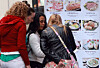 Foreign tourists look at Korean food menus in Myeongdong, central Seoul, on Oct. 20. [YONHAP]