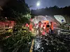 Firefighters and officials work to remove fallen trees off the streets of Bupyeong District, Incheon, on July 16. Trees fell due to landslides from the heavy rain, according to officials. [INCHEON FIRE DEPARTMENT]