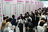Jobseekers sit down for consultations at company booths set up at a job fair in Busan on Sept. 10. [YONHAP]