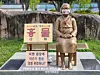 A statue of a girl symbolizing the victims of Japanese wartime sexual slavery, euphemistically referred to as comfort women, located in Jecheon, North Chungcheong, is seen with a sign that reads 'remove,' installed by a far-right civic organization. [SCREEN CAPTURE]