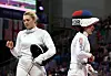 Korean fencer Song Se-ra, right, reacts after losing to Eszter Muhari of Hungary in the women’s epee individual table of 16 at the Paris Olympics at Grand Palais in Paris on Saturday. [JOINT PRESS CORPS]