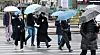 Pedestrians walk by Gwanghwamun Square in central Seoul with umbrellas on April 14. [NEWS1]