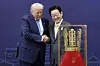President Lee Jae Myung, right, shakes hands with U.S. President Donald Trump after presenting him with the Grand Order of Mugunghwa and a model of the Cheonmachong gold crown at the Gyeongju National Museum in Gyeongju, North Gyeongsang, on Oct. 29, 2025. [JOONGANG ILBO]