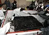 The fire authorities conduct a joint investigation on burned battery modules from a Mercedes EQE EV that burst into flames in an underground parking garage in an apartment complex in Incheon on Aug. 1. [NEWS1]
