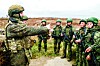 A Russian firearms instructor, left, gives instructions to North Korean soldiers who were involved in Russian military operations in the Kursk region in this undated footage shared by the Russian state media on April 28. [SCREEN CAPTURE]