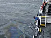 The South Korean Navy and Coast Guard conduct containment operations after diesel fuel leaked during an internal fuel transfer aboard a naval vessel docked at a Navy pier near Somo Island in Jinhae District, Changwon, South Gyeongsang, on May 11. [CHANGWON COAST GUARD]