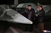 North Korean leader Kim Jong-un, left, inspects what is believed to be a Hwasong-12Na intermediate-range hypersonic missile at an undisclosed strategic missile base, as shown in this photo released by the North's Korean Central News Agency on Wednesday. [YONHAP]