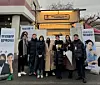 Muhammad Naufal Bin Omar, far right, poses for a photo with Glutanex's ambassador actor Song Ji-hyo, third from right, in front of a food truck prepared for the cast and crew of her upcoming film ″Home Behind Bars.″ [MUHAMMAD NAUFAL BIN OMAR]