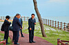President Lee Jae Myung, right, and Japanese Prime Minister Shigeru Ishiba, center, take a walk around the Nurimaru APEC House in Busan on Sept. 30 after their bilateral summit. [PRESIDENTIAL OFFICE]