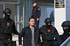Montenegrin police officers escort South Korean citizen and Terraform Labs founder Do Kwon in Montenegro's capital Podgorica, Saturday, March 23, 2024. Kwon was transferred on Saturday from prison, where he had served a four-month sentence for using a fake passport, to a facility for foreigners pending his announced extradition to his native Korea. [AP/YONHAP]