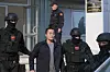 Montenegrin police officers escort South Korean citizen and Terraform Labs founder Do Kwon in Montenegro's capital Podgorica, Saturday, March 23, 2024. Kwon was transferred on Saturday from prison, where he had served a four-month sentence for using a fake passport, to a facility for foreigners pending his announced extradition to his native Korea. [AP/YONHAP]