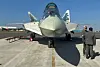 Officials stand next to a parked Russian Sukhoi Su-57 stealth fighter jet during the Aero India 2025 air show at Yelahanka air base in Bengaluru, India on Feb. 11. [REUTERS/YONHAP]