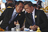 Cambodian Senate President Hun Sen, left, talks with his son Prime Minister Hun Manet, right, during the 74th founding anniversary in Phnom Penh, Cambodia, Saturday, June 28, 2025. (AP Photo/Heng Sinith)