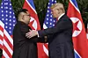 U.S. President Donald Trump, right, shakes hands with North Korea leader Kim Jong-un at the Capella resort on Sentosa Island in Singapore on June 12, 2018. [AP/YONHAP]