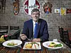 Paul Duclos, Peru’s ambassador to Korea, poses with traditional Peruvian dishes during an interview with the Korea JoongAng Daily at Ceviche 210 in Pyeongtaek, Gyeonggi, on July 17. [PARK SANG-MOON]