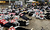 Protesters stage a die-in, a form of protest where demonstrators lie on the ground as though dead, in front of Exit 10 of Gangnam Station on Seoul Metro Line 2 in Gangnam District, southern Seoul, on May 18. [YONHAP]