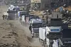 Trucks carrying humanitarian aid enter the Gaza Strip from Egypt in the southern Gaza town of Rafah, Feb. 12. [AP/YONHAP]