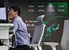 A trader works at the Hana Bank trading room in central Seoul on July 1, the first day of the won-dollar trading hour extension. [YONHAP]