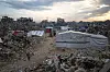 Palestinians walk in the destruction caused by the Israeli air and ground offensive in Jabaliya, Gaza Strip, on Feb. 11. [AP/YONHAP]