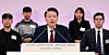 President Yoon Suk Yeol announces support measures for small merchants and the self-employed during a public policy debate session in Gongju, South Chungcheong on Monday. [YONHAP]