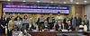 Lawmakers and presenters of a seminar on establishing carbon reduction guidelines for live performances pose for photos while holding K-pop light sticks at the National Assembly in western Seoul on Dec. 2. [SHIN HA-NEE]