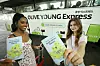 Tourists pose for a photo in front of CJ Olive Young's tourism vehicle, the ″Olive Young Express.″ [OLIVE YOUNG]