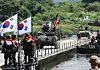 U.S. Stryker armored vehicles and Korean K200 armored vehicles cross a floating bridge during a Korea-U.S. joint river-crossing exercise in Yeoju, Gyeonggi on Aug. 27. [YONHAP]