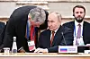 Vladimir Putin, President of Russia, listens to his press secretary Dmitry Peskov during an expanded meeting of the Supreme Eurasian Economic Council at the Palace of Independence on June 27. [TASS/YONHAP]