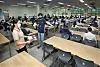 A teacher guides a student to her seat in the school’s cafeteria, where social distancing is practiced. [PARK SANG-MOON]