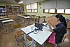 An English teacher prerecords her lesson in an empty classroom to upload online. [PARK SANG-MOON]