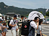 A passerby covers his face with a large fan in downtown Seoul as the capital experiences hot summer weather on Monday. Seoul's daily temperature peaked at 30.2 degrees Celsius (86.4 degrees Fahrenheit) the same day, according to the Korea Meteorological Administration. [YONHAP]