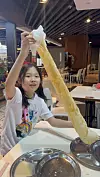Park Chan-mi’s daughter tries eating Roti tissue, a popular, paper-thin and crispy Malaysian sweet flatbread, at NZ Curry House, a local restaurant in Kuala Lumpur, on Dec. 16, 2025. [PARK CHAN-MI]