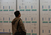 A job seeker looks at a recruitment board during the 2025 Busan Job Festival, an event offering employment opportunities for all age groups, at Bexco in Haeundae District, Busan, on Oct. 27. [SONG BONG-GEUN]