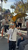 Logan Lee, who traveled to Sydney with his mother for a month in 2024, experiences a bird landing on his head at Circular Quay on Aug. 10, 2024. [MILA JIN]
