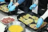 Pan-fried beef fritters are made by people gathered at a community center in Gwangju on Feb. 13. [NEWS1]
