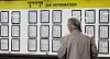 An older adult looks at a job information bulletin in Mapo District, western Seoul on Tuesday. [NEWS1]