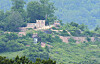 A North Korean loudspeaker used for anti-South broadcasts is visible in front of a guard post north of the inter-Korean border, as seen from the South’s side in Gyeonggi on Aug. 13. [YONHAP]