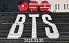 A tourist takes a photo in front of a promotion for BTS's new album, 'Arirang,' at the Sejong Center for the Performing Arts in Jongno District, central Seoul, on Jan. 22. [YONHAP]