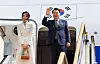 President Yoon Suk Yeol, right, waves alongside first lady Kim Keon Hee as they depart on the presidential jet from the Seoul Air Base in Gyeonggi, on Tuesday beginning a weeklong visit to Indonesia and India for Asean and G20 events. [JOINT PRESS CORPS]