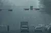 Vehicles wait for the green light on a street in Gwangju as fine dust caused smog on Jan. 16. [NEWS1]