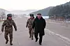 In this photo released by the Rodong Sinmun on Jan. 5, North Korean leader Kim Jong-un, right, walks down a road near the site of what the newspaper described as a 'hypersonic missile launch test' that took place the previous day. [NEWS1]